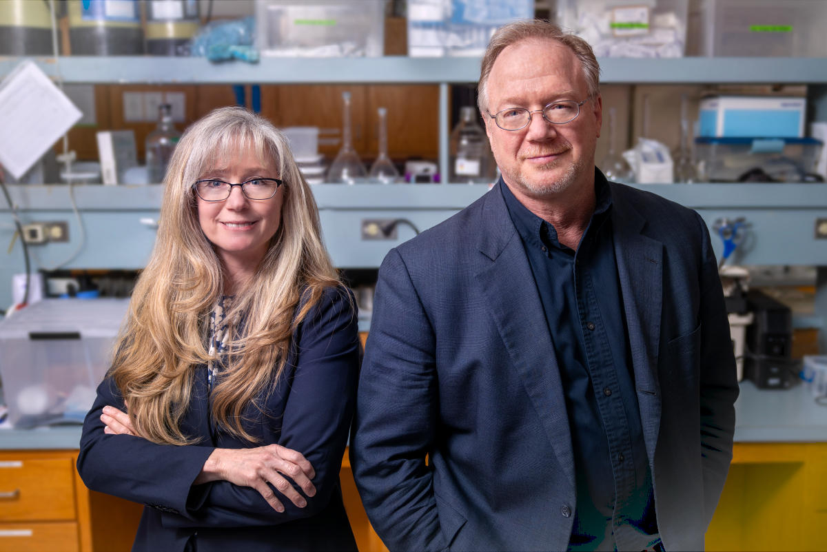 Patricia Grigson and Scott Bunce pose for a portrait in a research lab